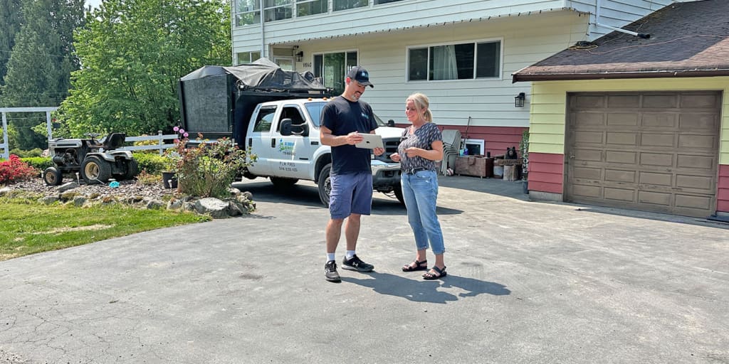 Big Phil's Rubbish Removal professional discussing the junk removal prices to a customer