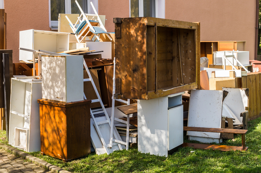 a pile of furniture outside a building
